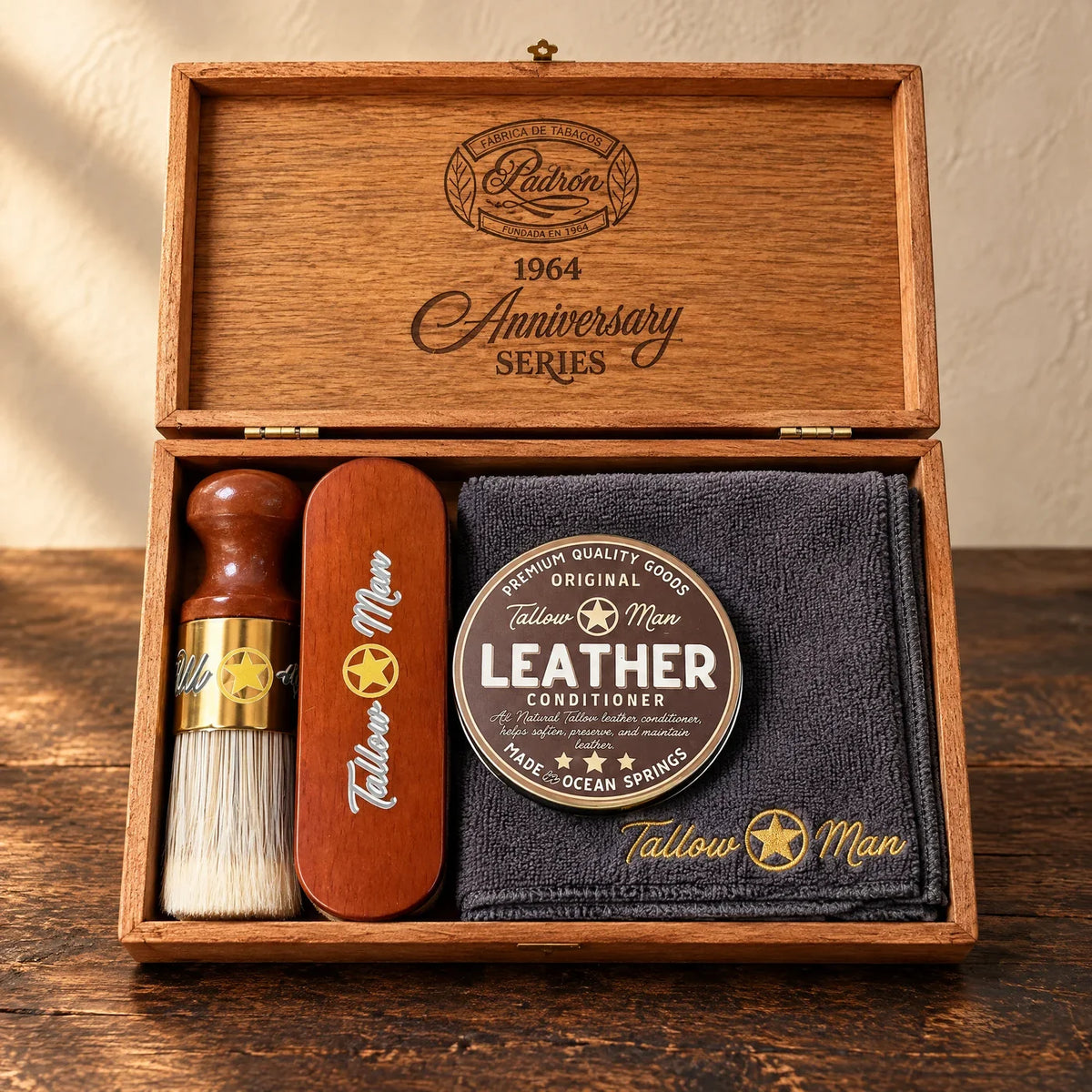 Tallow Man Deluxe Leather Kit in an open wooden presentation box with conditioner tin, application brush, buffing brush and embroidered cloth