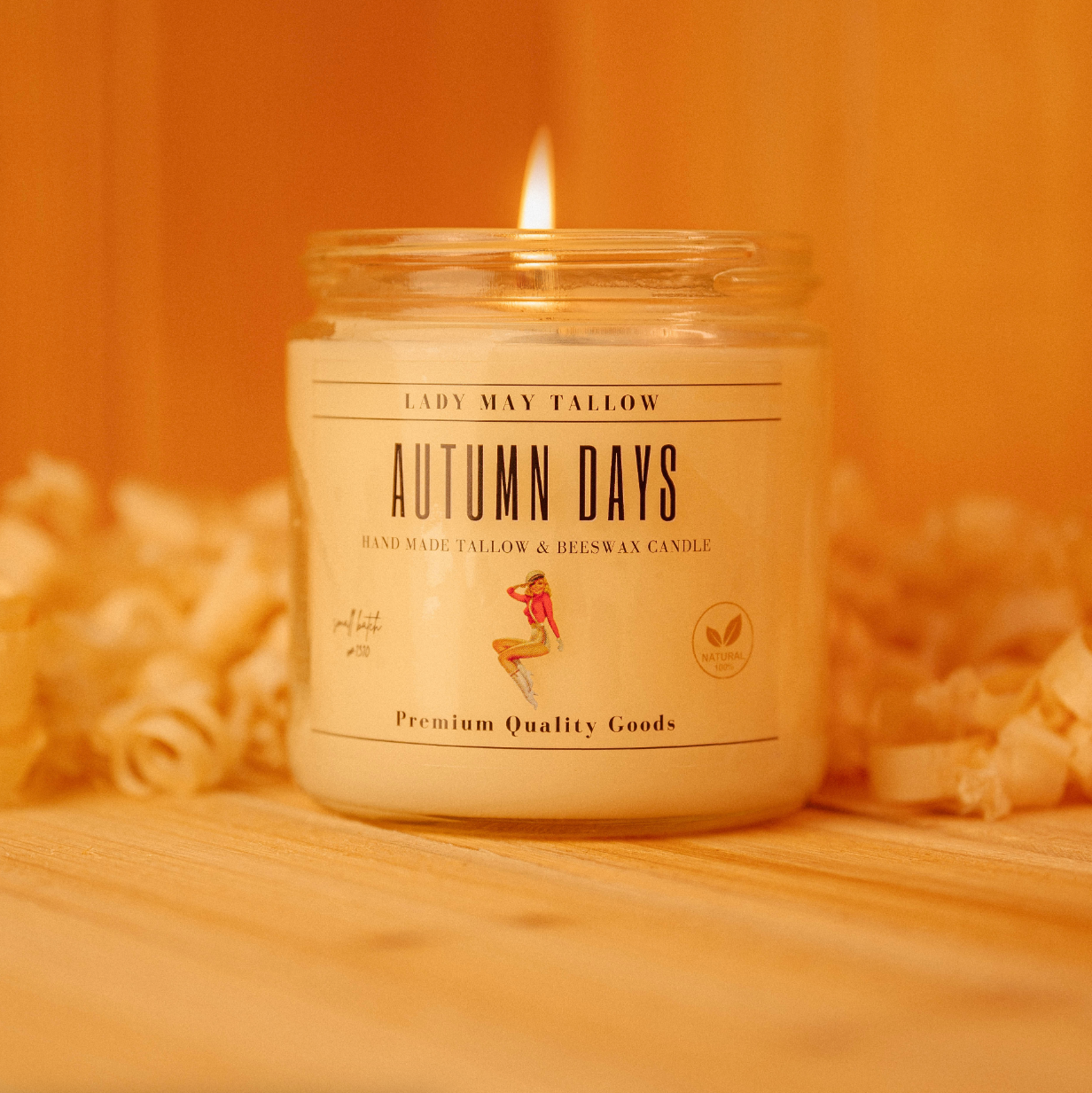 Alt Tag: Seasonal Tallow &amp; Beeswax Candle 16oz | Non Toxic Grass-Fed All-Natural Clean Burning Autumn Days jar candle lit on wood surface