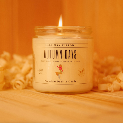 Alt Tag: Seasonal Tallow &amp; Beeswax Candle 16oz | Non Toxic Grass-Fed All-Natural Clean Burning Autumn Days jar candle lit on wood surface