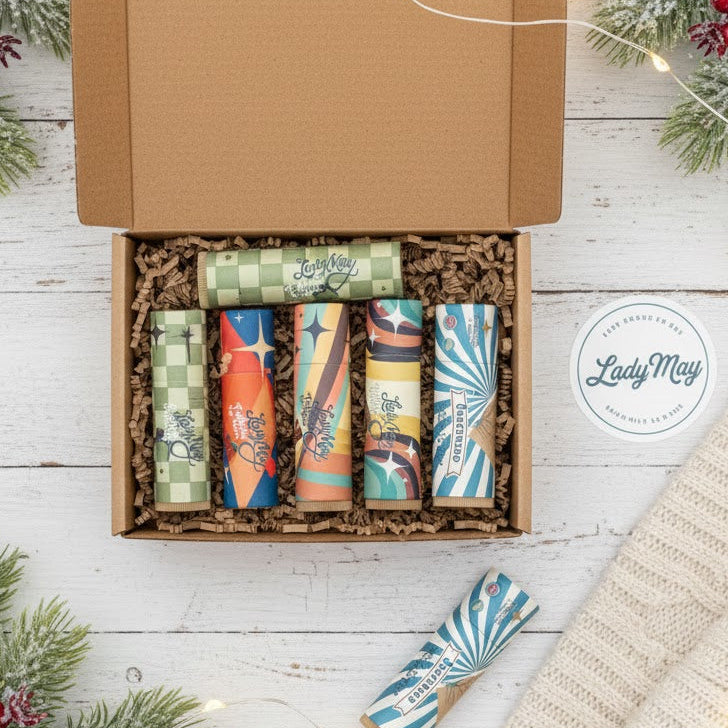 Open cardboard box with colorful items on a festive background with Christmas decorations.